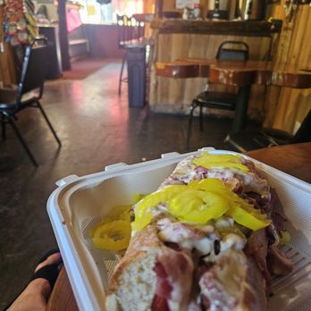 Rocky's Roadhouse - Pastrami on toasted roll with Swiss cheese, pickles and peppercinis - Delis Near Me - Running Springs, California Rocky's Roadhouse - Pastrami on toasted roll with Swiss cheese, pickles and peppercinis - Delis Near Me - Running Springs, California