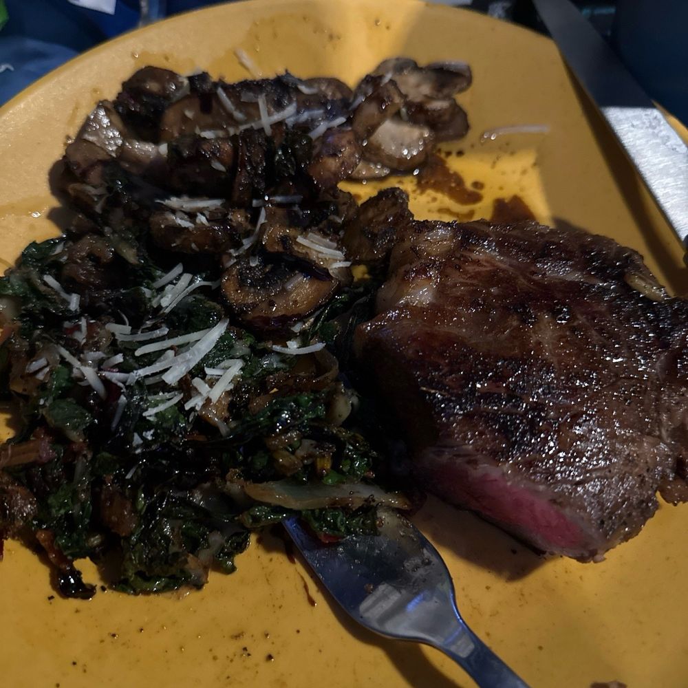 Fish Tales Market & Eatery - Drunken NY strip (half) i served it with swiss chard and sautéed mushrooms - Seafood Near Me - Marathon, Florida