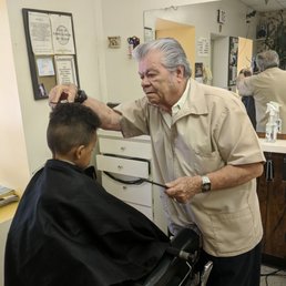 The barber Dion cutting my son's hair. The barber Dion cutting my son's hair.
