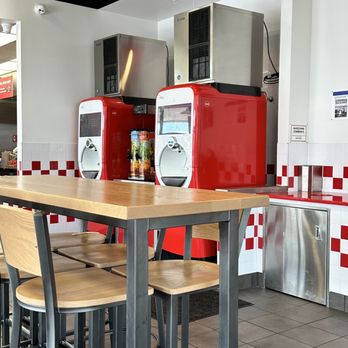 Five Guys - a kitchen with a table and chairs - Burgers Near Me - Winter Park, Florida