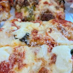 Margherita pizza in front and Pizza Di Roma in the bay