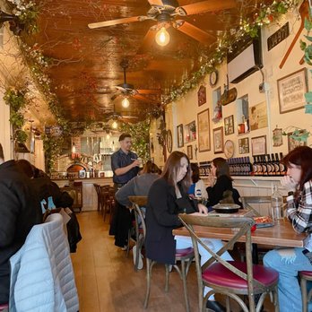 Capizzi - people sitting at tables in a restaurant - Pizza Near Me - New York, New York Capizzi - people sitting at tables in a restaurant - Pizza Near Me - New York, New York
