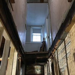 Sam Rosario Construction - Gaping hole they from dirt floor basement, through the uninsulated demo area, into the 2nd floor where the bedrooms and bathroom were.