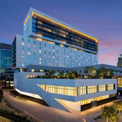 Skyline Building Care - Contemporary commercial building featuring glass architecture, illuminated exterior lighting, landscaped surroundings, and pr...