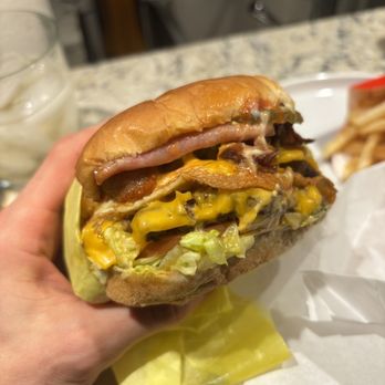 Eat That Burger - a hand holding a sandwich - American Near Me - North Hollywood, California