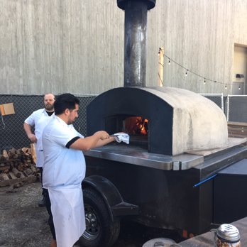 Roberta's - Baking pizza pies in mobile stone oven on trailer and wheels. - Pizza Near Me - Culver City, California