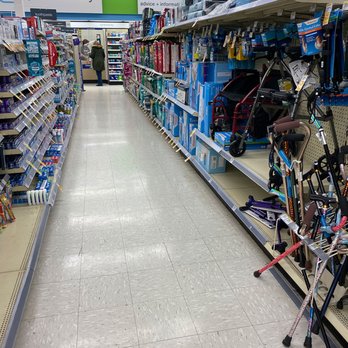 CVS Pharmacy - the aisles of a pharmacy store - The image shows an aisle inside CVS Pharmacy, featuring shelves stocked with health services, immunizations, dental care, and mobility aids such as walkers and canes. A customer is seen in the background browsing the shelves. The store has a clean, well-lit environment with signage indicating pharmacy and health-related sections. - Drugstores Near Me - Norridge, Illinois