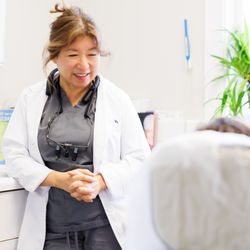 Premier Dental Center - Dr. Linh Vu during an exam with a patient.