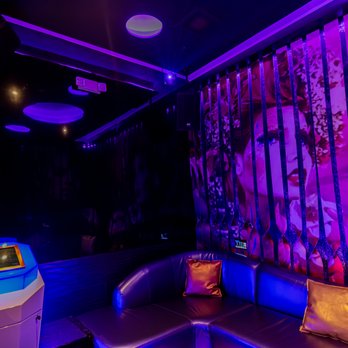 Wave KTV - a couch and a table in a brightly lit room - Karaoke Near Me - Queens, New York Wave KTV - a couch and a table in a brightly lit room - Karaoke Near Me - Queens, New York