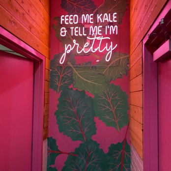 Fresh Kitchen - a painted wall with a sign saying feed me kale and tell me i'm pretty - New American Near Me - Tampa, Florida