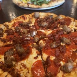 Carnivore pizza In foreground; special, Italian in background. Carnivore pizza In foreground; special, Italian in background.