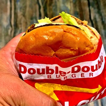 In-N-Out Burger - ows a hand holding a double decker sandwich - Burgers Near Me - Pinole, California