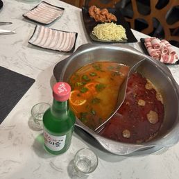 Spicy broth and Thai broth, along with peach Soju Spicy broth and Thai broth, along with peach Soju