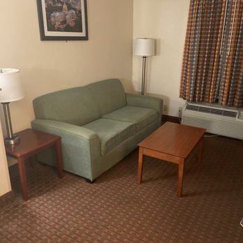Quality Inn - Couch and coffee table there also a desk - Hotels Near Me - Clinton, Mississippi Quality Inn - Couch and coffee table there also a desk - Hotels Near Me - Clinton, Mississippi