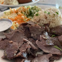 Lamb döner kebab with pilaf rice, potatoes and salad