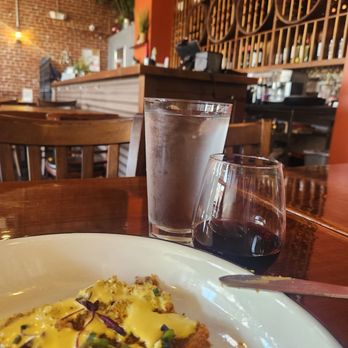 Aji Peruvian Cuisine - Water, red wine, and a steak cutlet that I asked for a side of their sauce(apparently dairy free) but tastes spicy and cheesy...soooo good! - Peruvian Near Me - Long Beach, California