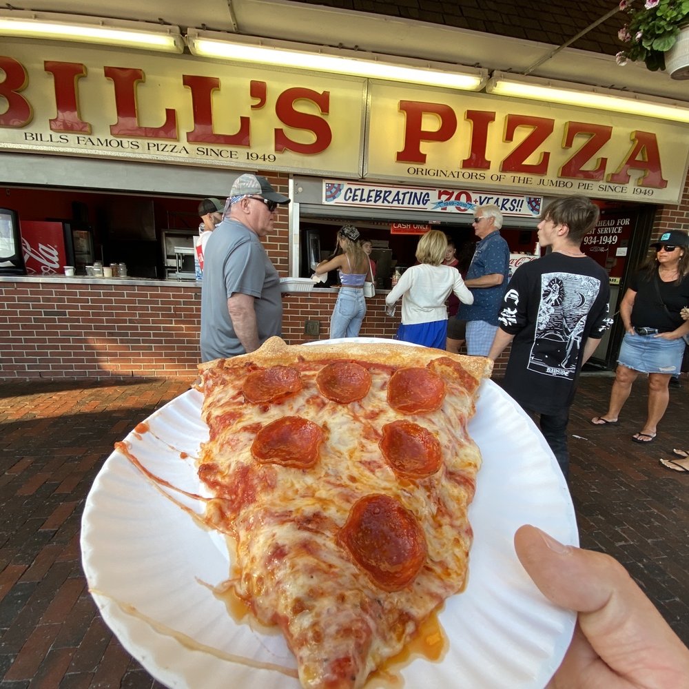 a slice of pepperoni pizza on a paper plate