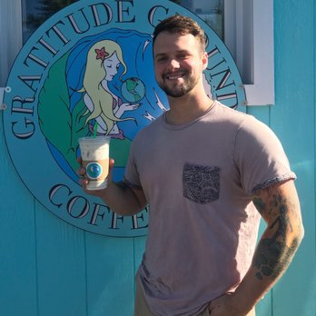 Gratitude Grounds Coffee - a man holding a cup of coffee - Coffee & Tea Near Me - Tacoma, Washington