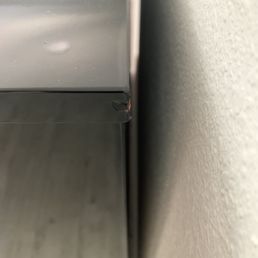 Facing the piano (upper back right side smashed)