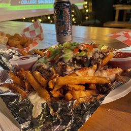 a plate of fries and a can of soda a plate of fries and a can of soda