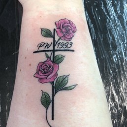 Memorial tattoo with cross and pink roses Memorial tattoo with cross and pink roses