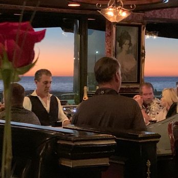 21 Oceanfront - Our view from our booth looking towards the bar and the ocean abit of an obstruction in the way, but you can still see the. - New American Near Me - Newport Beach, California