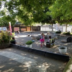 The Cottage Montessori School - Calm outdoor play area where children can help take care of herbs and flowers.