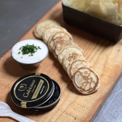 Social Charcuterie Bar & Cocktails - White Sturgeon caviar with sour cream, blini, Mrs. Fishers potato chips