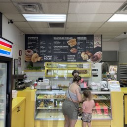 a woman and a child in front of the counter a woman and a child in front of the counter