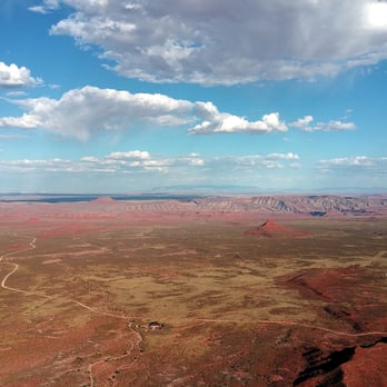 Moki Dugway - Valley of the Gods as background.  You can see Route 261 and Valley of the Gods Road.  The builiding is the V of the G Bed and Breakfast. - Landmarks & Historical Buildings Near Me - Mexican Hat, Utah