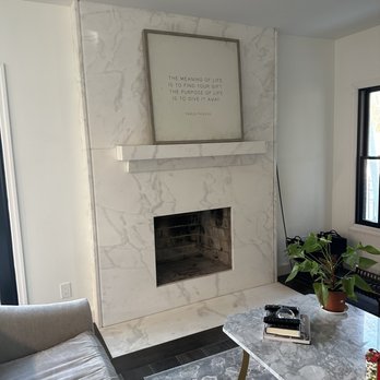 Renaissance Marble Works - a living room with a fireplace - General Contractors Near Me - Mineola, New York Renaissance Marble Works - a living room with a fireplace - General Contractors Near Me - Mineola, New York