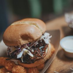 Iyla's Southern Kitchen - Pulleed Pork BBQ Sandwich topped with slaw and BBQ sauce