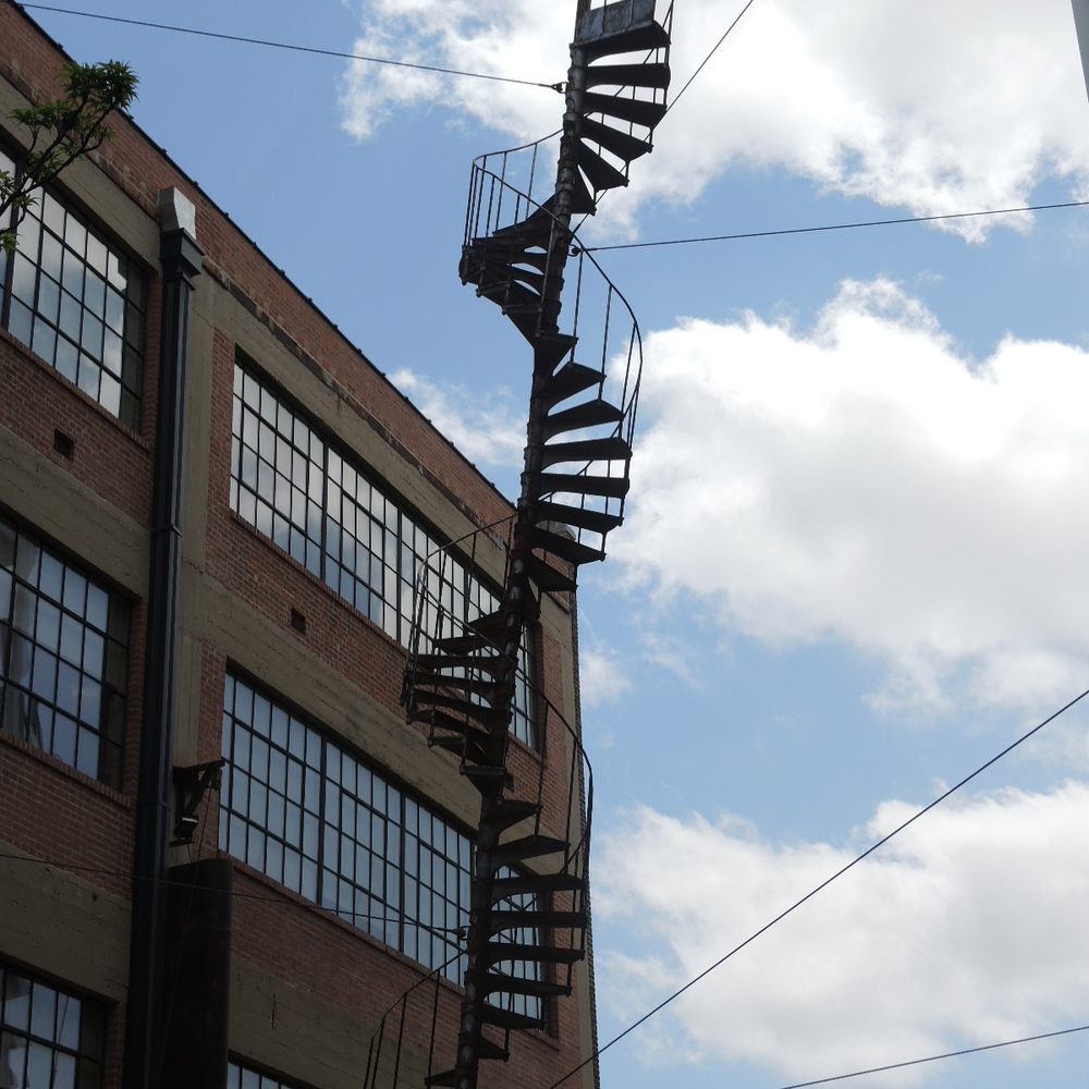 Architectural DNA - Spiral fire escape sculpture titled Architectural DNA between buildings - Public Art Near Me - Oklahoma City, Oklahoma