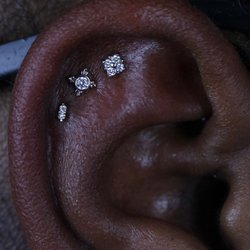 Studio 28 - Enhance your style with our exquisite triple helix piercings. Elevate your look and embrace the perfect trifecta of elegance. By Kirsten