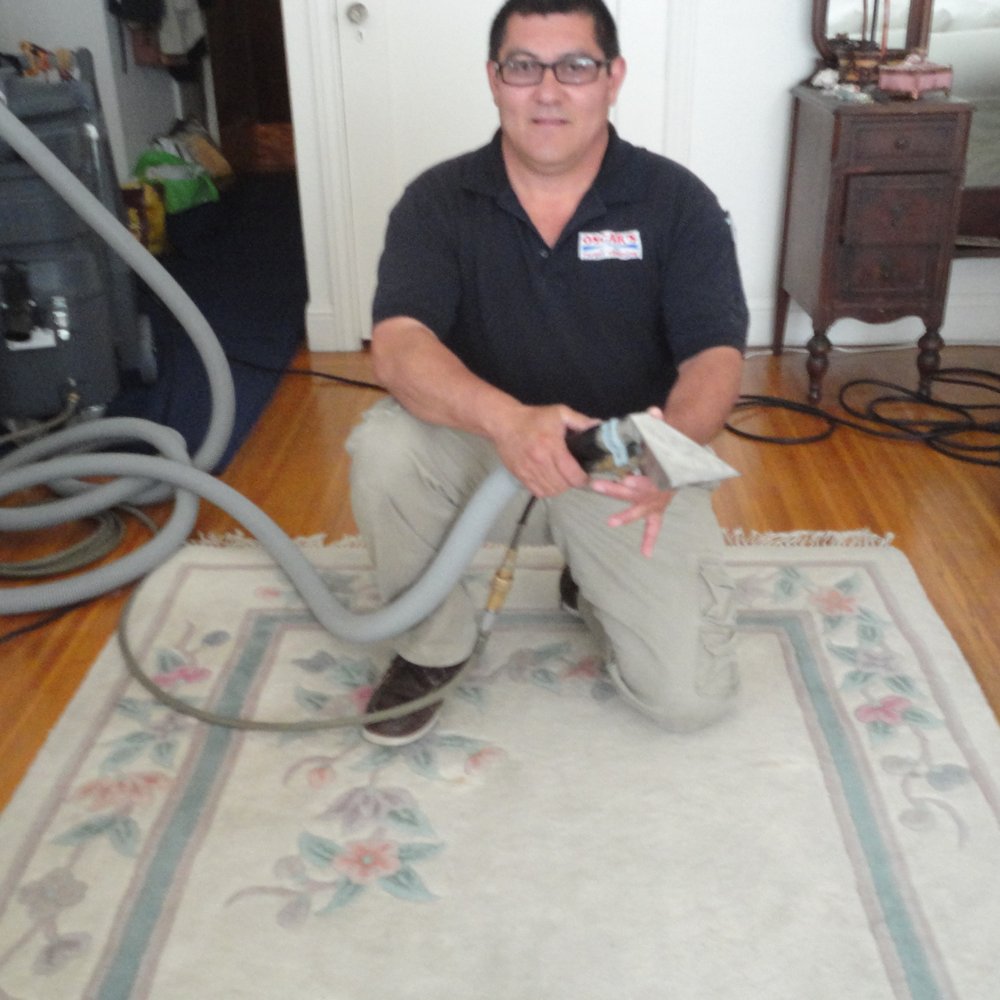 Oscar's Carpet Cleaning - Oscar with the rug before cleaning. Picture the rug three shades lighter for after. - Carpet Cleaning Near Me Oscar's Carpet Cleaning - Oscar with the rug before cleaning. Picture the rug three shades lighter for after. - Carpet Cleaning Near Me