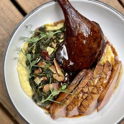 Palmettos on the Bayou - Grilled Duck a L'Orange with sweet corn grits, smoked duck leg, and braised Southern greens.