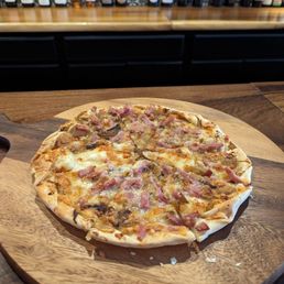 a pizza on a wooden cutting board