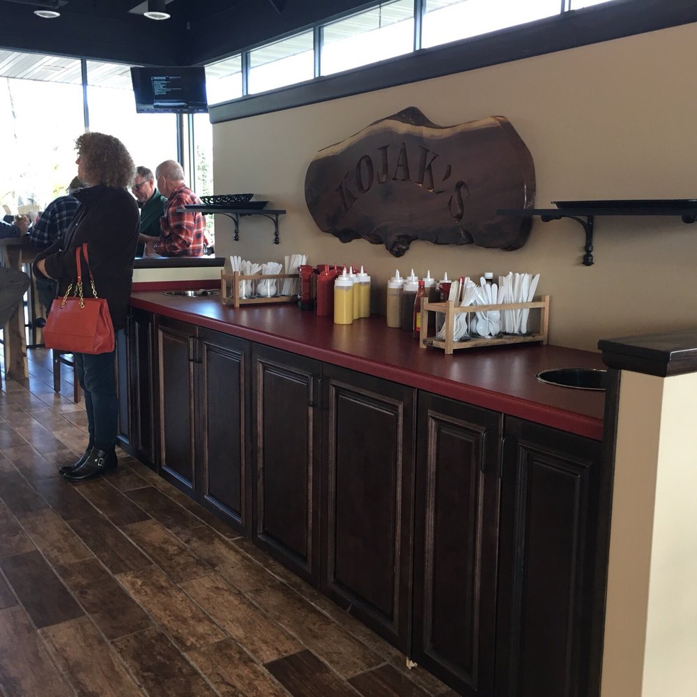 Kojak's - Nice little condiments area with Sriracha ketchup, some mustards, etc. Nice sign. - American Near Me - Cary, Illinois Kojak's - Nice little condiments area with Sriracha ketchup, some mustards, etc. Nice sign. - American Near Me - Cary, Illinois