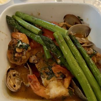 La Coquille - Halibut with mussels and shrimp in a lobster broth, including asparagus and tomatoes - French Near Me - Manhasset, New York La Coquille - Halibut with mussels and shrimp in a lobster broth, including asparagus and tomatoes - French Near Me - Manhasset, New York