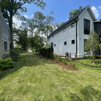 A Martinez Landscaping - a white house with a black roof - Landscaping Near Me - Chicago, Illinois
