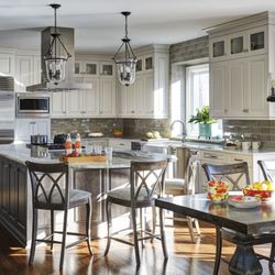 LSM Interiors - Saloom Furniture Counter Stools and Kitchen Table. Lantern Style Lights Over Large Island.