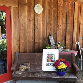 Alderlea Farm and Cafe - a wooden bench with flowers on it - Cafes Near Me - Duncan, British Columbia