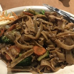 Pad Kee Mao. Wide rice noodles, bell pepper, carrots, basil, protein and spicy brown sauce!!  Very good.  Large portions!