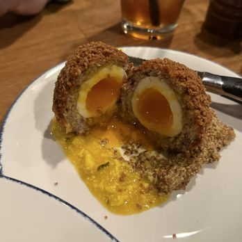 Farmers Gastropub - GF Scotch Egg sitting 2 types of mustard - Gastropubs Near Me - Springfield, Missouri