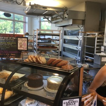 Brick Oven Bakery - a woman standing in front of a bakery counter - Bakeries Near Me - Northfield, Minnesota