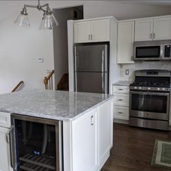 TommaHawk Home Improvements - Complete kitchen remodel with new cabinets, backsplash, hardwood floors, and countertop
