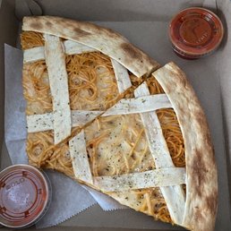 slice of spaghetti with side sauce