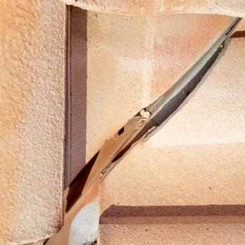 All About Roofing - Adhesive used to seal holes in bent flashing. Looks exactly like the stuff on my garage door. Right! - Roofing Near Me - Surprise, Arizona