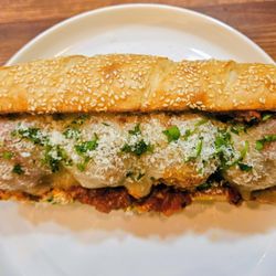 Little Italian Kitchen - House baked Italian bread filled with our homemade beef and pork meatballs, marinara, melted Provolone, and Parmigiano Reggiano.