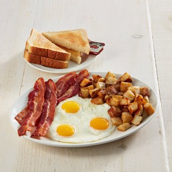 Sunset Grill - Four strips of premium bacon, three eggs, and home fries served with thick toast. - Breakfast & Brunch Near Me - Hamilton, Ontario Sunset Grill - Four strips of premium bacon, three eggs, and home fries served with thick toast. - Breakfast & Brunch Near Me - Hamilton, Ontario